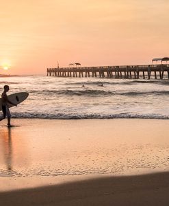 Surfer Walking at Sunrise