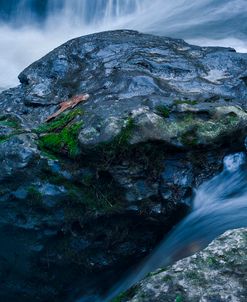 Massive Moss Covered Rock Under Waterfalls