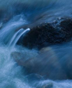 Rock Poking Through Swirling Warter