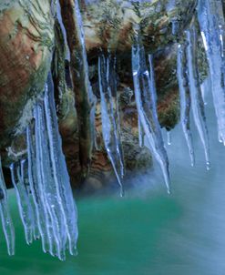 Ice Cicles On Mossy Stump With Icy Water