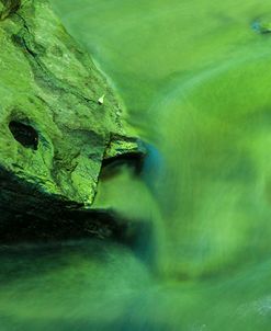Interesting Rock In Green Light On Water At Dawn
