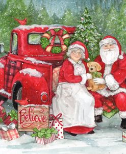 Santa and Mrs. Claus In Old Truck With Pup