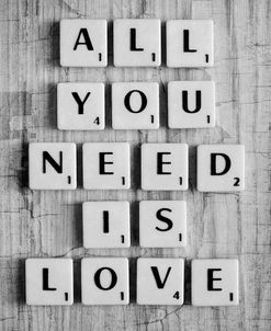 All you need is Love Written in Scabble Tiles on Wood