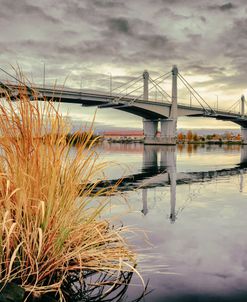A Large Bridge Over A River On A Cloudy Autumn Day